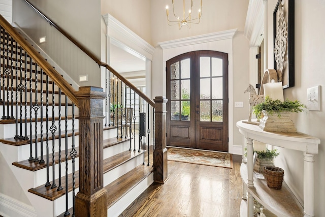 624 Twin View Dr, Murfreesboro, TN 37128 - entryway with french doors, wood finished floors, a chandelier, stairs, and a towering ceiling