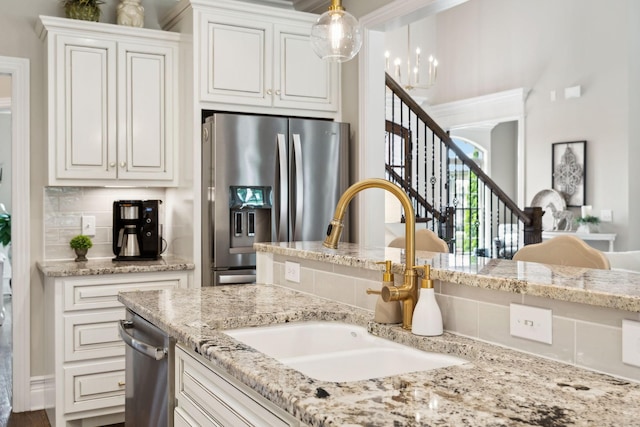624 Twin View Dr, Murfreesboro, TN 37128 - kitchen with stainless steel appliances, white cabinets, light stone countertops, hanging light fixtures, and backsplash