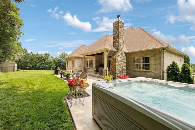 624 Twin View Dr, Murfreesboro, TN 37128 - rear view of property featuring brick siding, a hot tub, a yard, and a patio