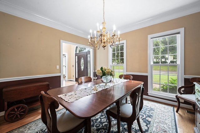 395 Glendower Pl, Franklin, TN 37064 - dining area with a chandelier, ornamental molding, wood finished floors, and healthy amount of natural light