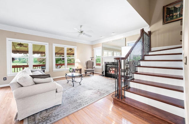 395 Glendower Pl, Franklin, TN 37064 - living room featuring a fireplace with flush hearth, stairs, ceiling fan, wood finished floors, and ornamental molding