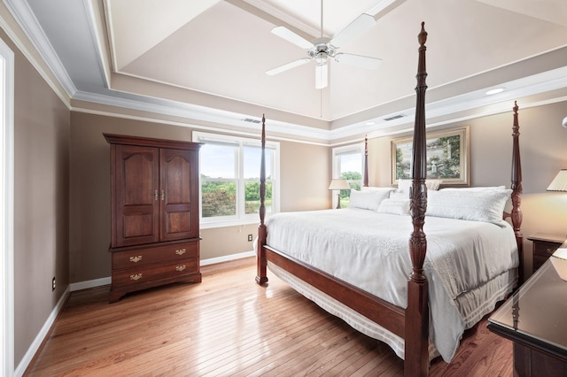395 Glendower Pl, Franklin, TN 37064 - bedroom featuring light wood finished floors, ornamental molding, a tray ceiling, and a ceiling fan
