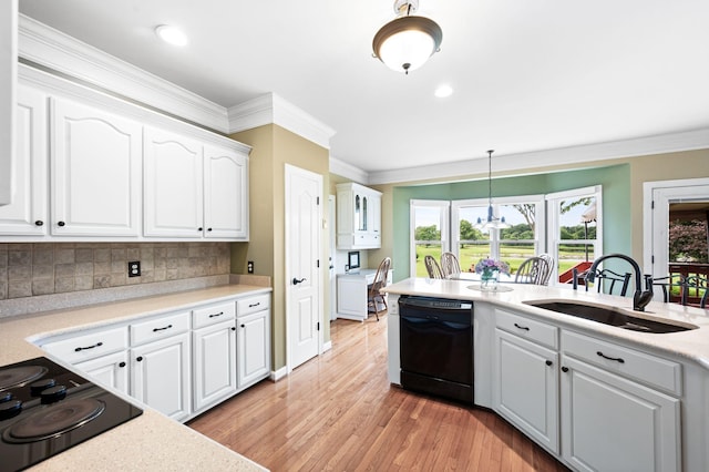 395 Glendower Pl, Franklin, TN 37064 - kitchen featuring black appliances, white cabinets, light wood-style flooring, light countertops, and ornamental molding
