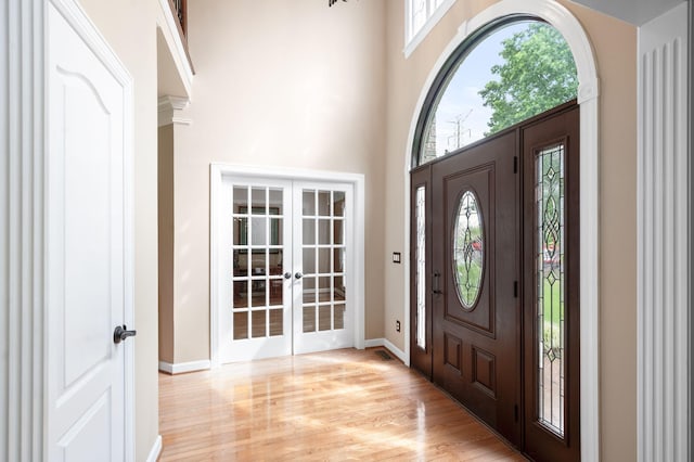 395 Glendower Pl, Franklin, TN 37064 - foyer featuring french doors, light wood-style floors, and a towering ceiling