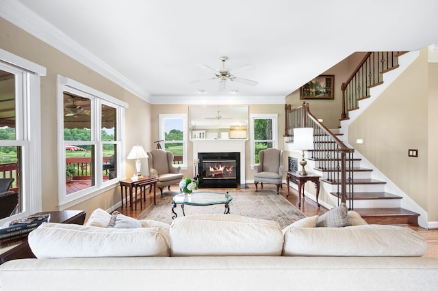 395 Glendower Pl, Franklin, TN 37064 - living room featuring ceiling fan, wood finished floors, stairs, a glass covered fireplace, and crown molding
