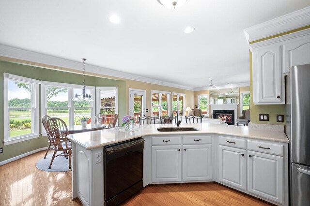 395 Glendower Pl, Franklin, TN 37064 - kitchen featuring dishwasher, freestanding refrigerator, a glass covered fireplace, light countertops, and ornamental molding