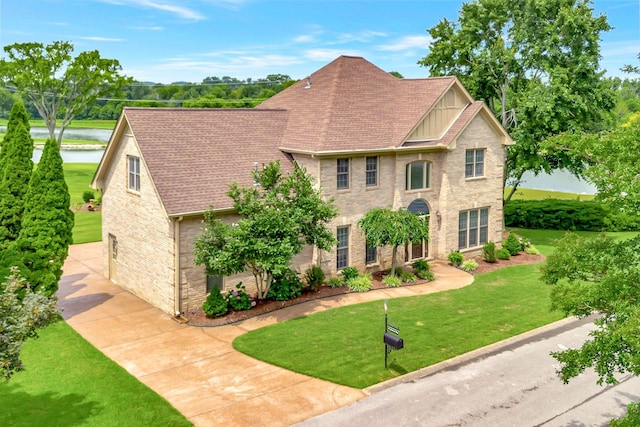 395 Glendower Pl, Franklin, TN 37064 - view of front of property with a front yard, brick siding, a water view, a shingled roof, and board and batten siding