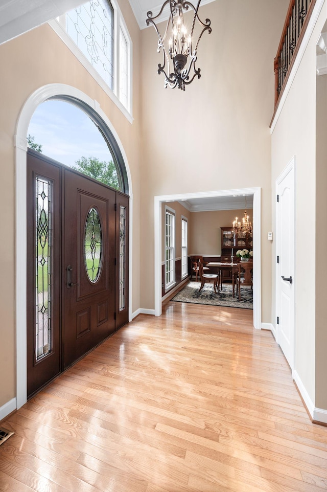 395 Glendower Pl, Franklin, TN 37064 - foyer entrance featuring a chandelier, a high ceiling, and light wood-style floors