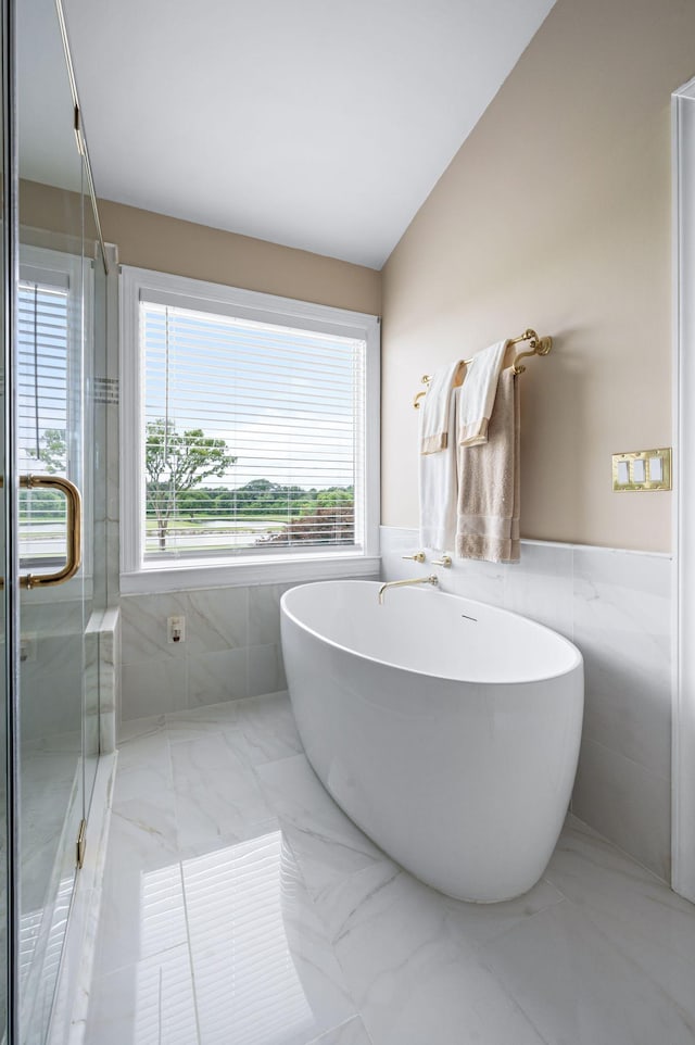 395 Glendower Pl, Franklin, TN 37064 - full bath with tile walls, a soaking tub, plenty of natural light, a wainscoted wall, and vaulted ceiling