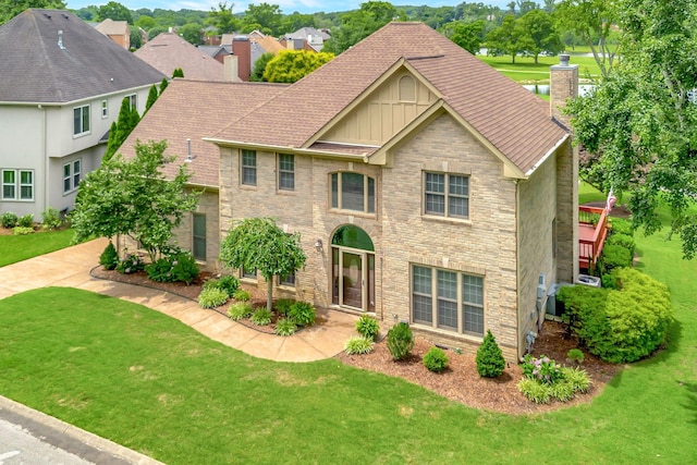 395 Glendower Pl, Franklin, TN 37064 - view of front facade with board and batten siding, a chimney, and a front lawn