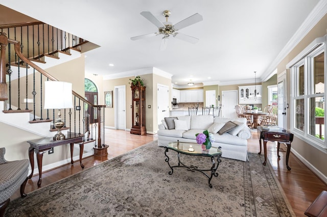 395 Glendower Pl, Franklin, TN 37064 - living area with crown molding, wood finished floors, ceiling fan, stairway, and recessed lighting