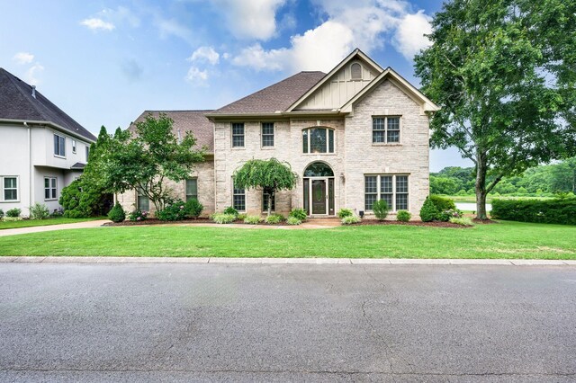 395 Glendower Pl, Franklin, TN 37064 - view of front of property with board and batten siding, a front lawn, and brick siding