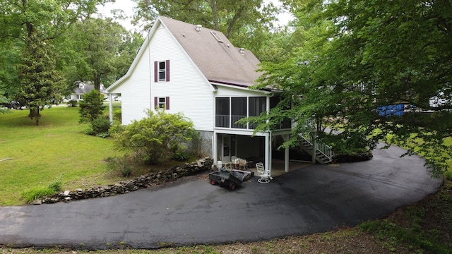 631 Mag A Mor Dr, Lafayette, TN 37083 - back of property with a sunroom, a patio, stairs, a yard, and roof with shingles