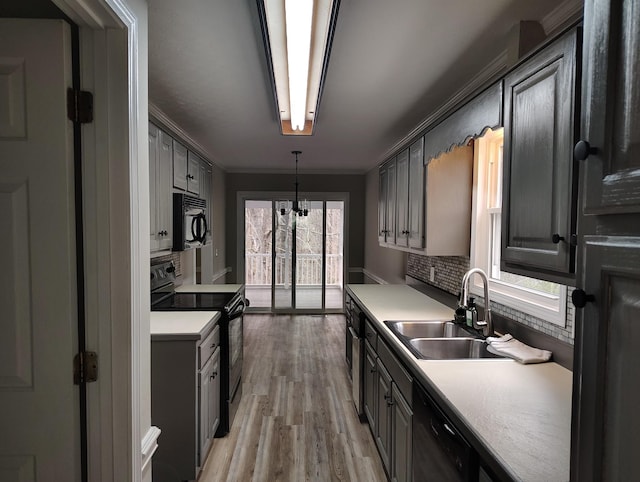 631 Mag A Mor Dr, Lafayette, TN 37083 - kitchen featuring black appliances, ornamental molding, light wood-style floors, light countertops, and pendant lighting