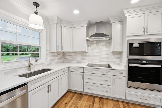 1061 Alford Rd, Murfreesboro, TN 37129 - kitchen with appliances with stainless steel finishes, wall chimney range hood, light countertops, white cabinets, and hanging light fixtures