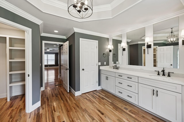 1061 Alford Rd, Murfreesboro, TN 37129 - bathroom featuring a chandelier, wood finished floors, double vanity, crown molding, and a raised ceiling