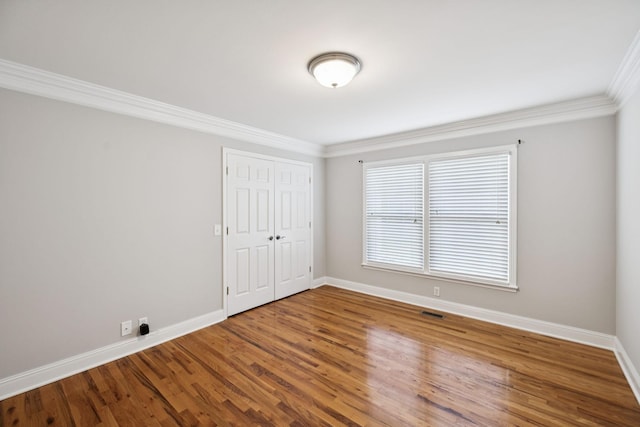 1061 Alford Rd, Murfreesboro, TN 37129 - unfurnished bedroom featuring ornamental molding, wood finished floors, and a closet
