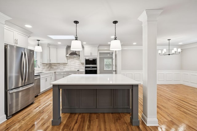 1061 Alford Rd, Murfreesboro, TN 37129 - kitchen with appliances with stainless steel finishes, light countertops, white cabinetry, decorative columns, and crown molding
