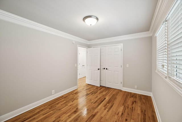 1061 Alford Rd, Murfreesboro, TN 37129 - unfurnished bedroom featuring crown molding, wood finished floors, multiple windows, and a closet