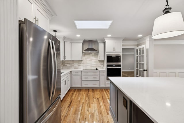 1061 Alford Rd, Murfreesboro, TN 37129 - kitchen featuring black appliances, wall chimney exhaust hood, a skylight, light countertops, and white cabinetry