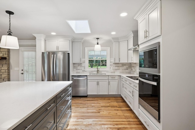 1061 Alford Rd, Murfreesboro, TN 37129 - kitchen with stainless steel appliances, a skylight, light countertops, white cabinets, and recessed lighting