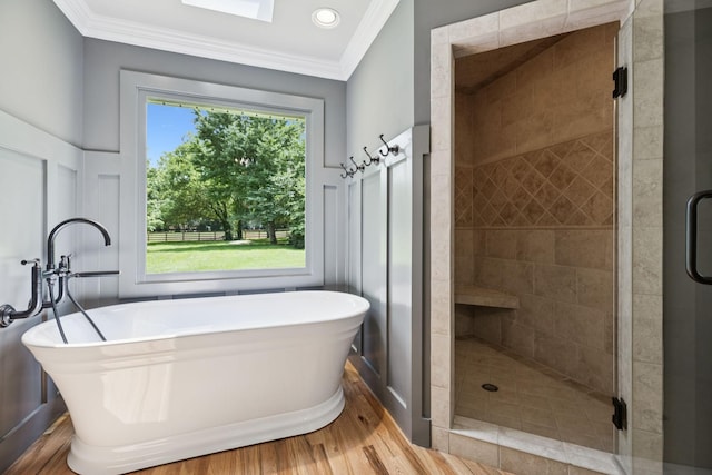 1061 Alford Rd, Murfreesboro, TN 37129 - full bathroom with wood finished floors, ornamental molding, a freestanding bath, a stall shower, and a decorative wall