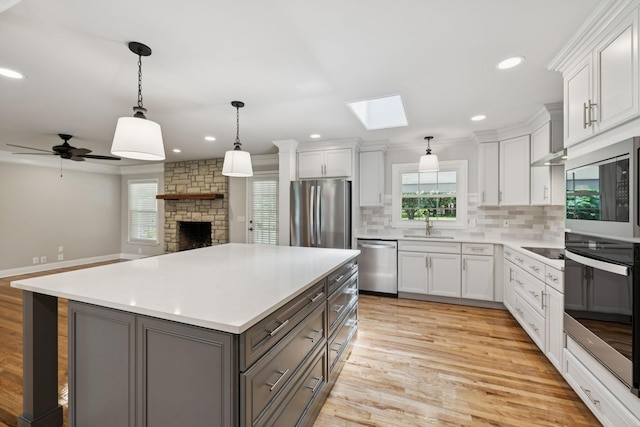 1061 Alford Rd, Murfreesboro, TN 37129 - kitchen featuring appliances with stainless steel finishes, healthy amount of natural light, decorative backsplash, a skylight, and recessed lighting