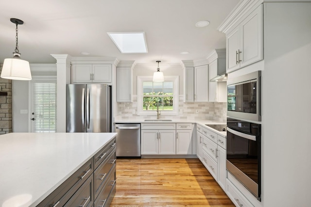 1061 Alford Rd, Murfreesboro, TN 37129 - kitchen featuring stainless steel appliances, a skylight, light countertops, plenty of natural light, and recessed lighting