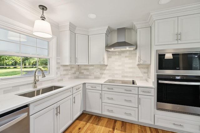 1061 Alford Rd, Murfreesboro, TN 37129 - kitchen featuring stainless steel appliances, wall chimney exhaust hood, white cabinetry, light countertops, and pendant lighting