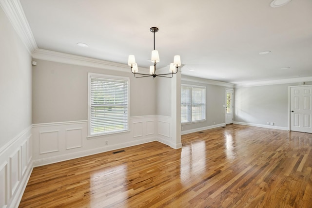 1061 Alford Rd, Murfreesboro, TN 37129 - spare room featuring a chandelier, healthy amount of natural light, light wood finished floors, wainscoting, and ornamental molding
