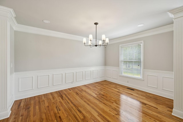 1061 Alford Rd, Murfreesboro, TN 37129 - empty room featuring a chandelier, wood finished floors, a wainscoted wall, and crown molding