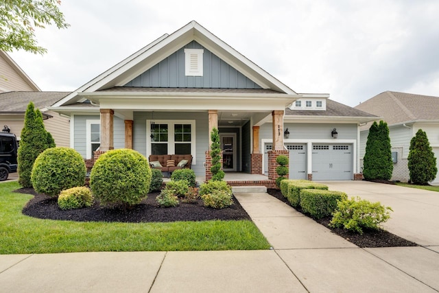 112 Misty Way, Hendersonville, TN 37075 - craftsman-style house featuring covered porch, board and batten siding, concrete driveway, an attached garage, and an outdoor hangout area