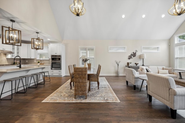773 Curve St, Chattanooga, TN 37405 - dining space with a chandelier, high vaulted ceiling, dark wood-style floors, and recessed lighting