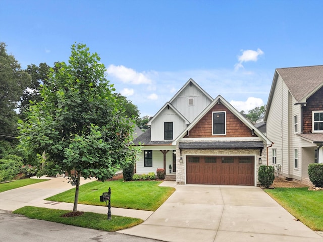 773 Curve St, Chattanooga, TN 37405 - craftsman house with concrete driveway, board and batten siding, a front lawn, and a garage