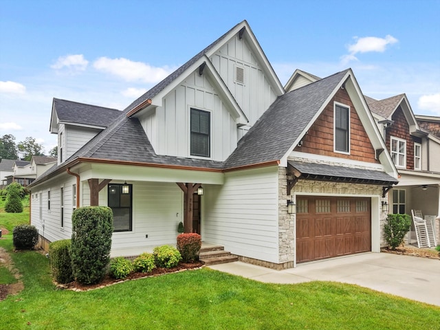 773 Curve St, Chattanooga, TN 37405 - view of front of house with board and batten siding, a garage, a front lawn, and concrete driveway