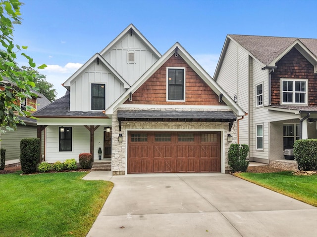 773 Curve St, Chattanooga, TN 37405 - craftsman house featuring board and batten siding, driveway, a front lawn, a porch, and a garage