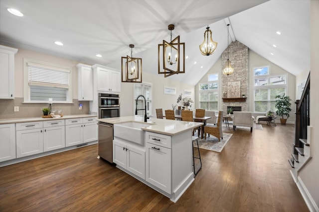 773 Curve St, Chattanooga, TN 37405 - kitchen featuring appliances with stainless steel finishes, dark wood-style flooring, white cabinets, light countertops, and high vaulted ceiling