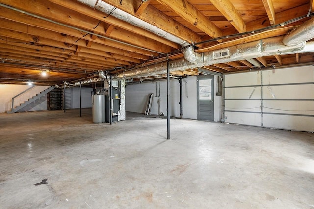 5058 New Chapel Rd, Springfield, TN 37172 - below grade area with water heater, stairs, and heating unit