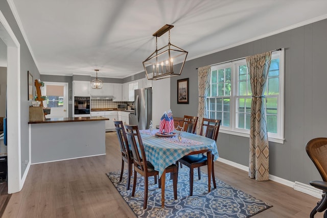 5058 New Chapel Rd, Springfield, TN 37172 - dining room with wood finished floors, a chandelier, and crown molding