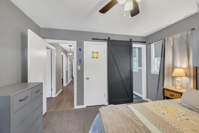 5058 New Chapel Rd, Springfield, TN 37172 - bedroom with a barn door, carpet floors, and ceiling fan