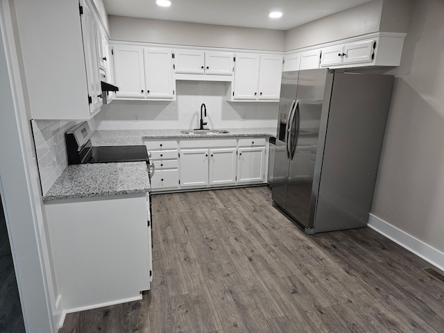 1204 W Lane St, Shelbyville, TN 37160 - kitchen featuring appliances with stainless steel finishes, white cabinetry, light stone counters, dark wood finished floors, and recessed lighting