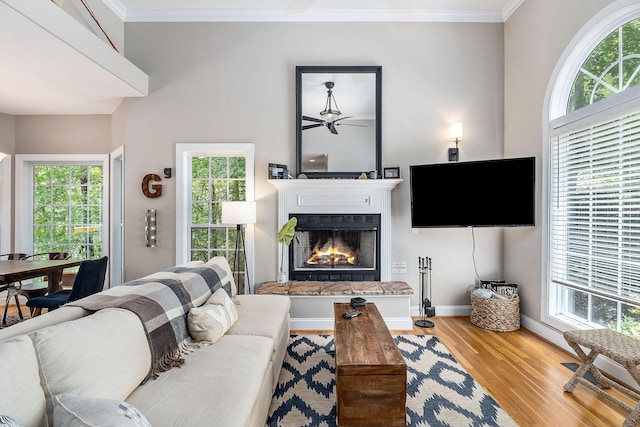 655 Lakeside Dr, Smithville, TN 37166 - living area with wood finished floors, a lit fireplace, ornamental molding, and ceiling fan
