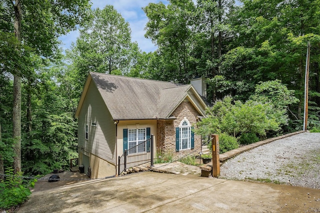 655 Lakeside Dr, Smithville, TN 37166 - view of front of property with stone siding, a chimney, and a shingled roof