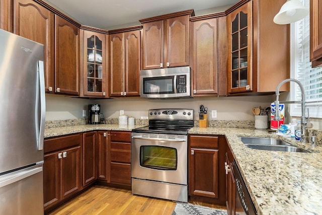 655 Lakeside Dr, Smithville, TN 37166 - kitchen featuring stainless steel appliances, light wood finished floors, light stone counters, and glass insert cabinets