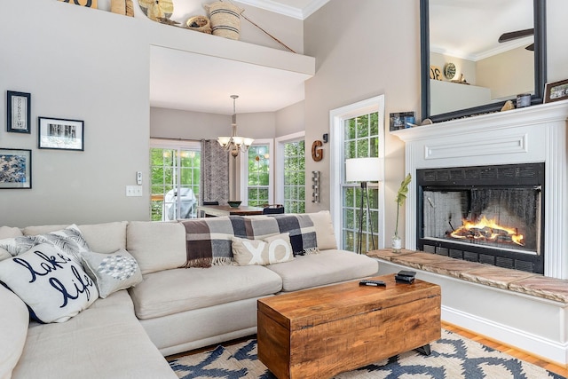 655 Lakeside Dr, Smithville, TN 37166 - living room featuring a chandelier, crown molding, a lit fireplace, and wood finished floors