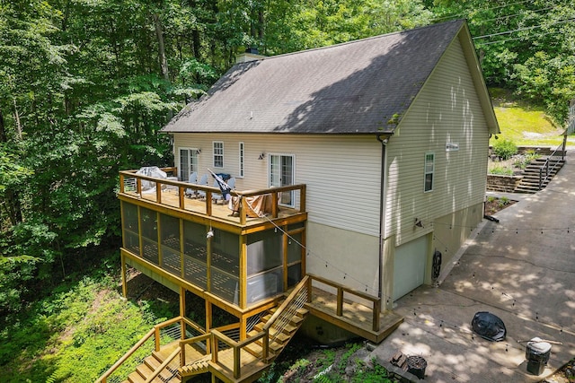 655 Lakeside Dr, Smithville, TN 37166 - back of property featuring a sunroom, a deck, stairway, and a shingled roof