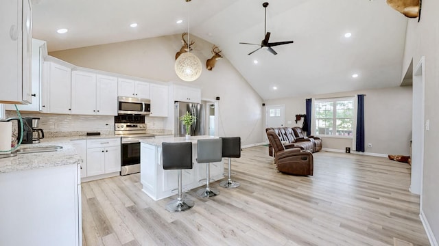 785 Grindstone Hollow Rd, Dickson, TN 37055 - kitchen featuring stainless steel appliances, high vaulted ceiling, open floor plan, a ceiling fan, and a center island