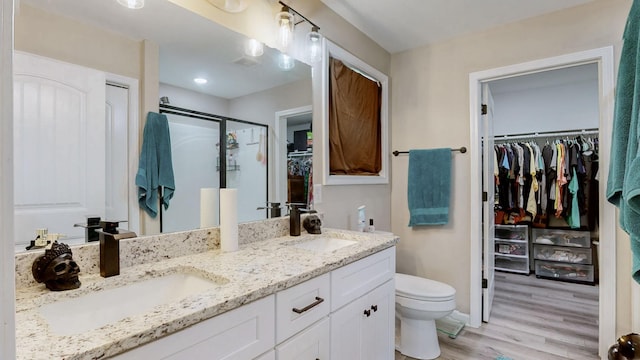 785 Grindstone Hollow Rd, Dickson, TN 37055 - bathroom featuring a spacious closet, double vanity, wood finished floors, and a shower stall