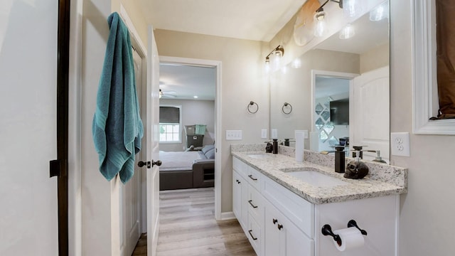 785 Grindstone Hollow Rd, Dickson, TN 37055 - bathroom with double vanity, connected bathroom, wood finished floors, and a ceiling fan