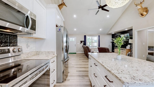 785 Grindstone Hollow Rd, Dickson, TN 37055 - kitchen with appliances with stainless steel finishes, open floor plan, light wood finished floors, a ceiling fan, and white cabinetry